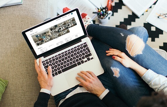 couple sharing a laptop with HomeByMe renderings on the screen