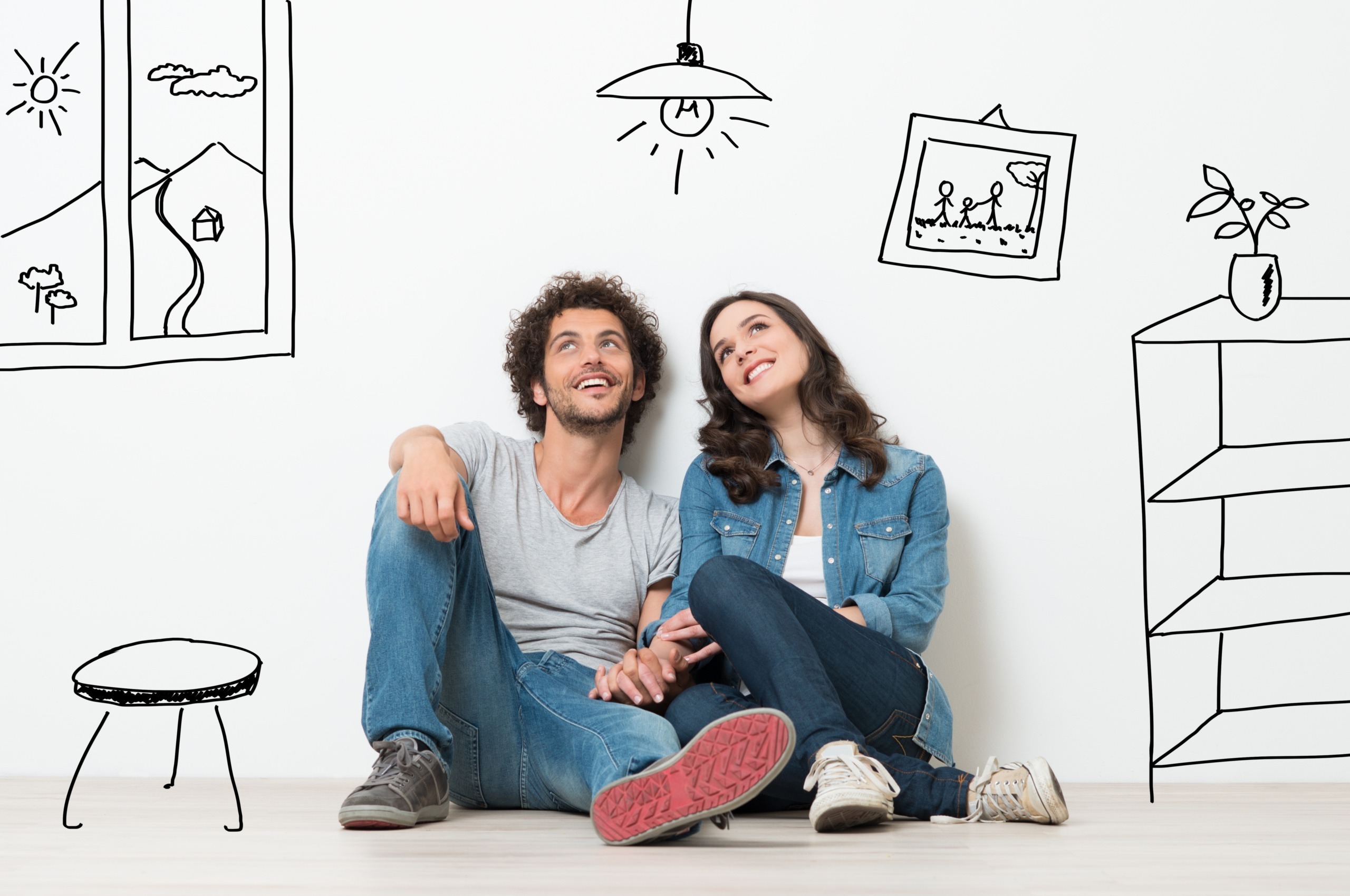 young couple daydreaming with cartoon images of new home