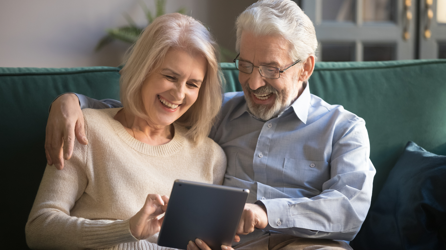 elderly couple designing on a tablet